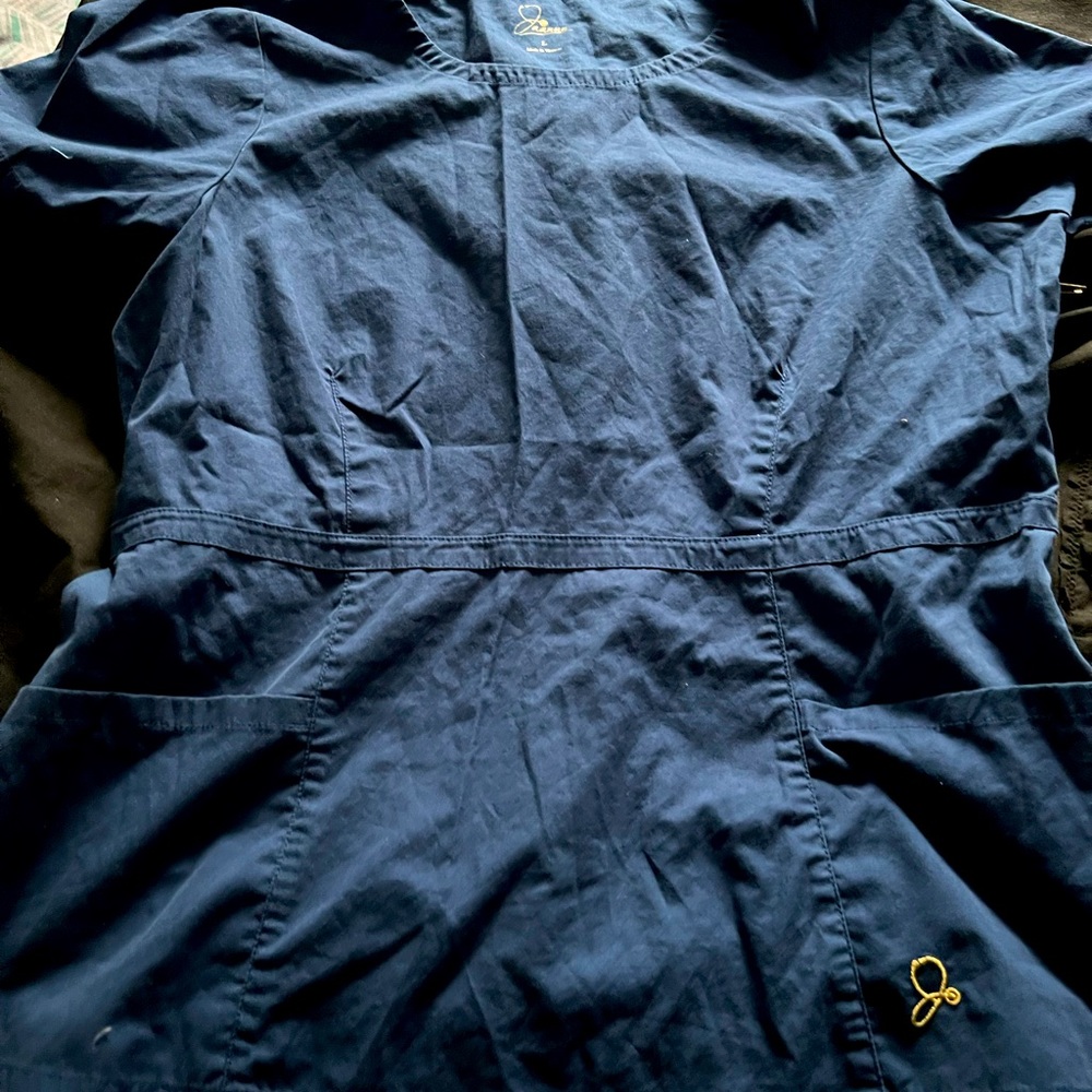 Large Jaanuu scrub peplum scrub top. Gold hard wear detailing zipper.